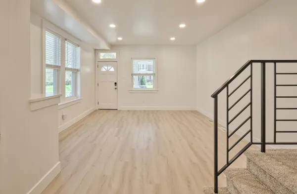 a view of an entryway with wooden floor