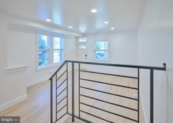 a view of entryway with wooden floor and front door