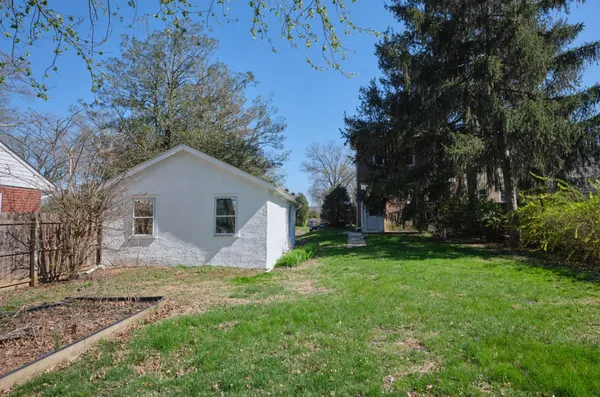 a view of a house with yard and a garden