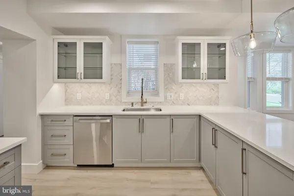 a kitchen with granite countertop white cabinets and sink