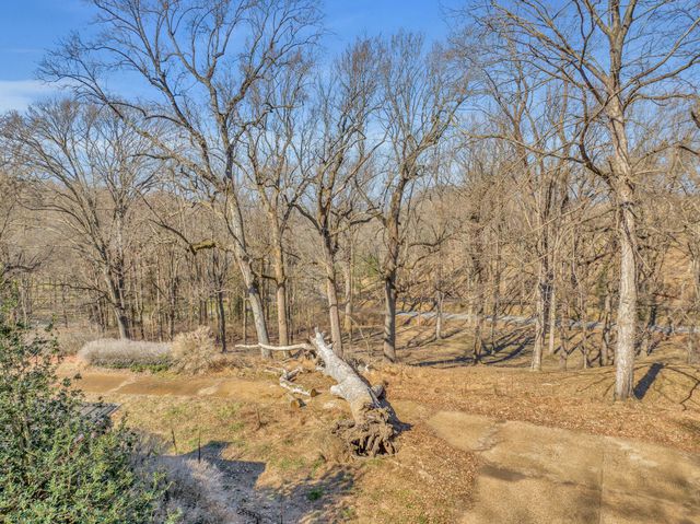 a view of yard covered with snow in front of house