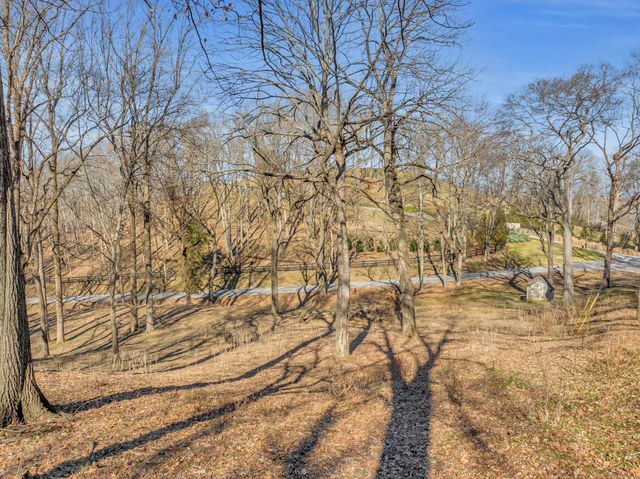 a view of yard covered with snow in front of house