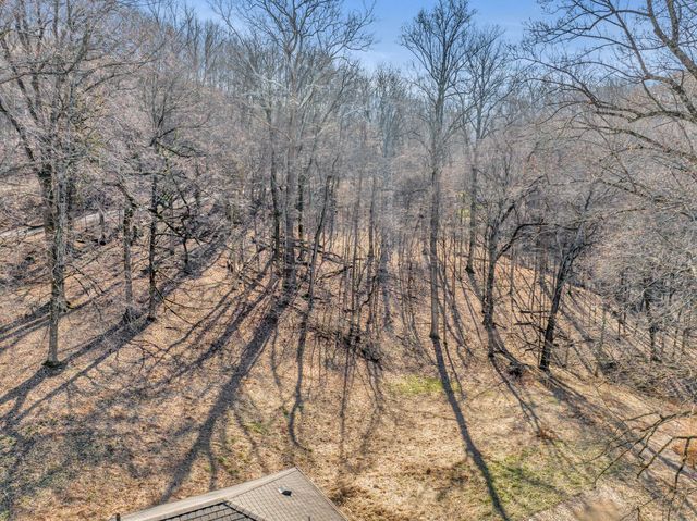 a view of empty space with wooden fence