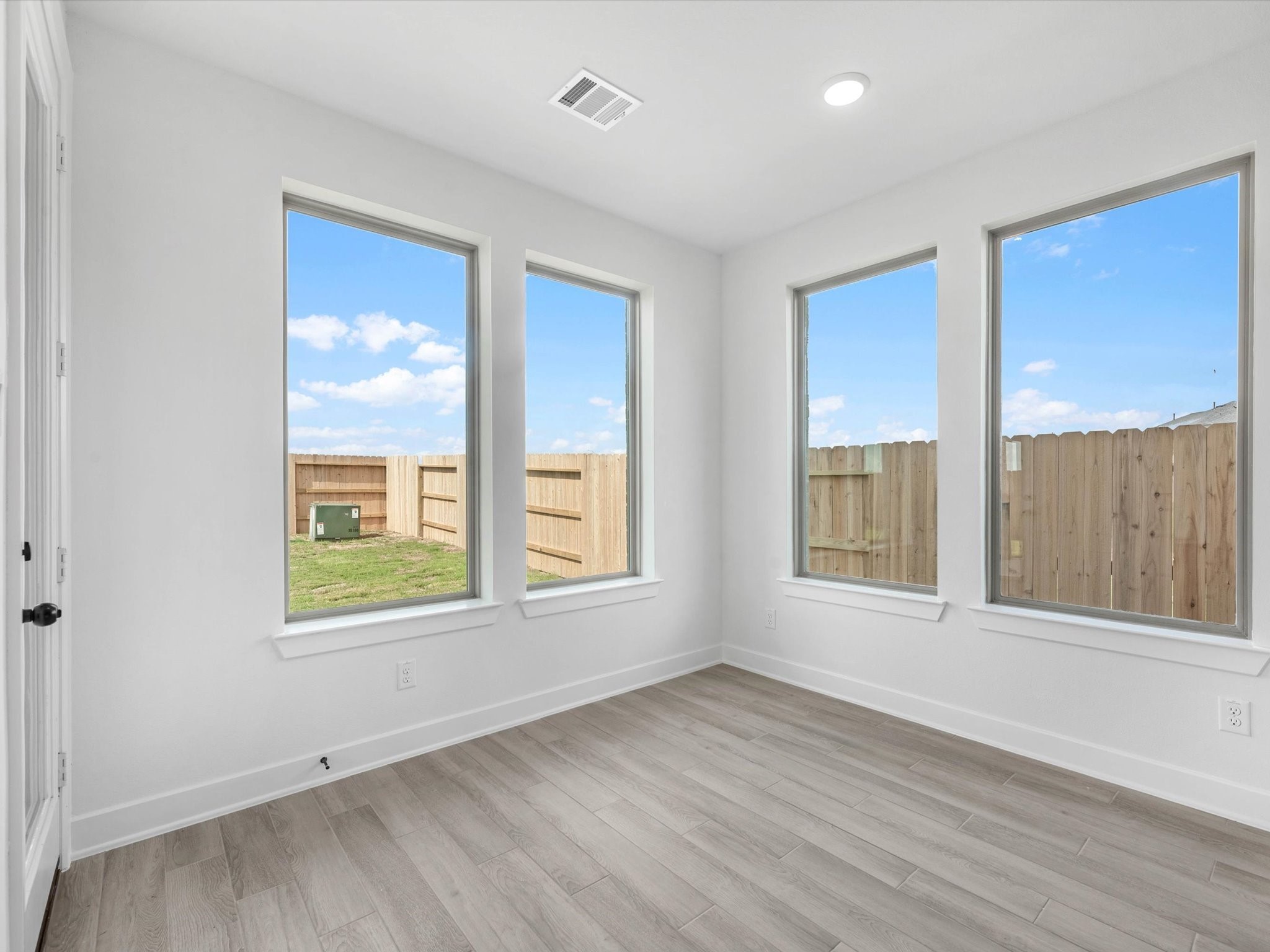 4911 Benton Wds Trail Rosenberg, TX 77471 - Photo 11 of 29 an empty room with wooden floor and windows
