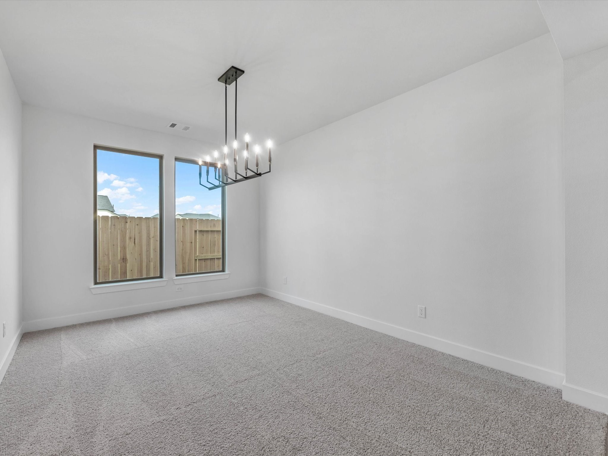 4911 Benton Wds Trail Rosenberg, TX 77471 - Photo 12 of 29 a view of an empty room with chandelier and window
