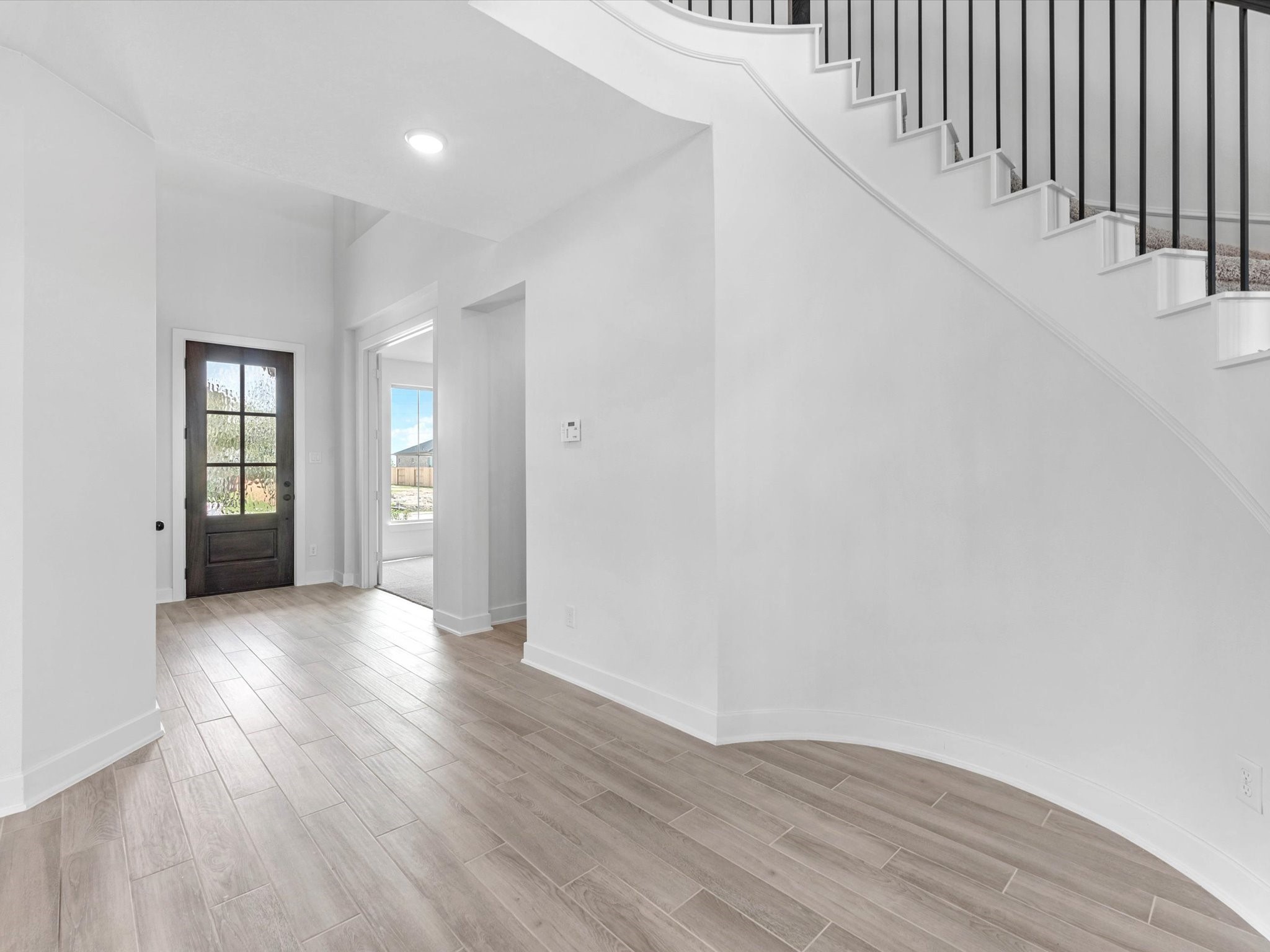 4911 Benton Wds Trail Rosenberg, TX 77471 - Photo 3 of 29 a view of a hallway with wooden floor and windows