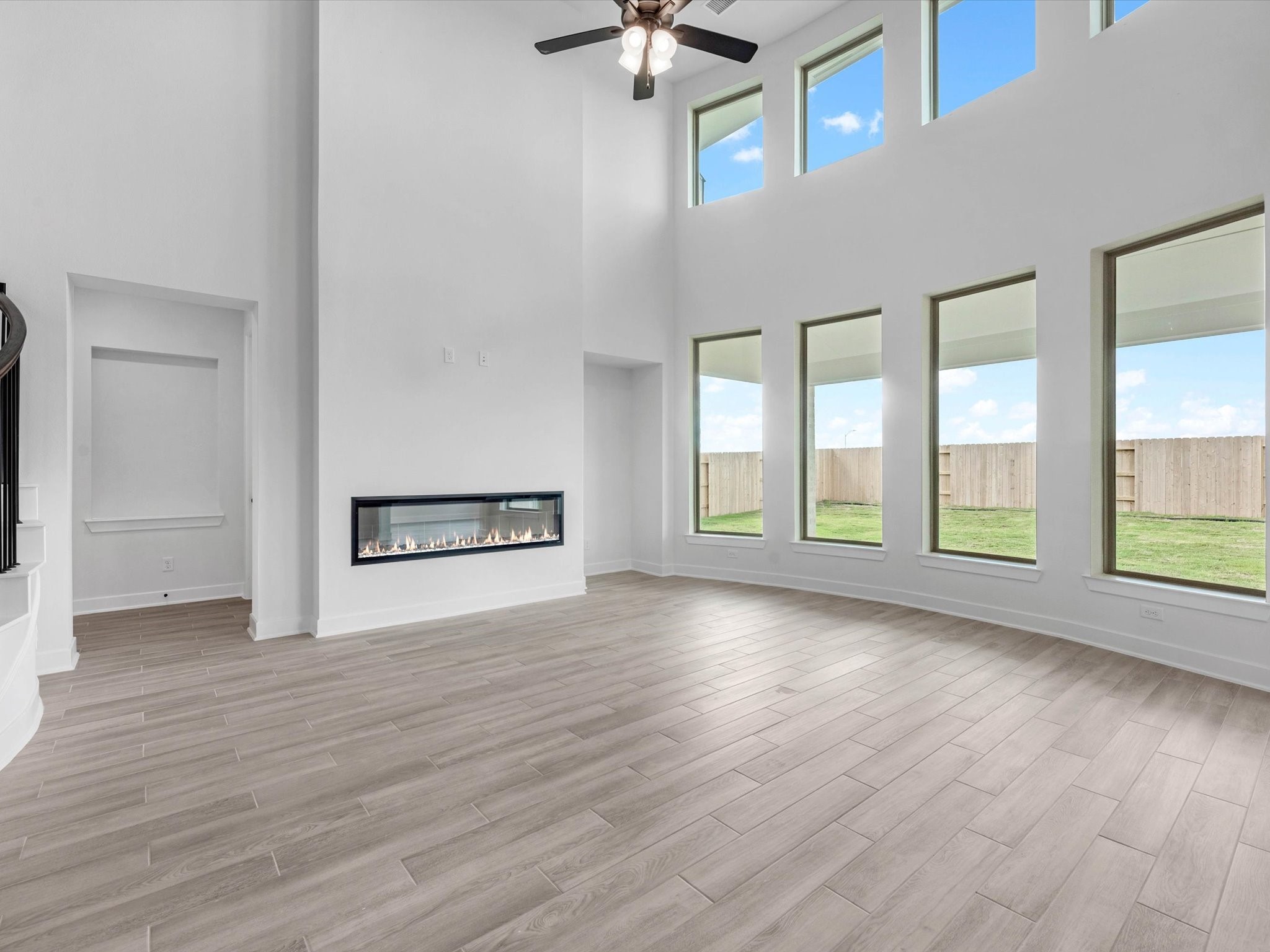 4911 Benton Wds Trail Rosenberg, TX 77471 - Photo 5 of 29 a view of an empty room with a window and wooden floor