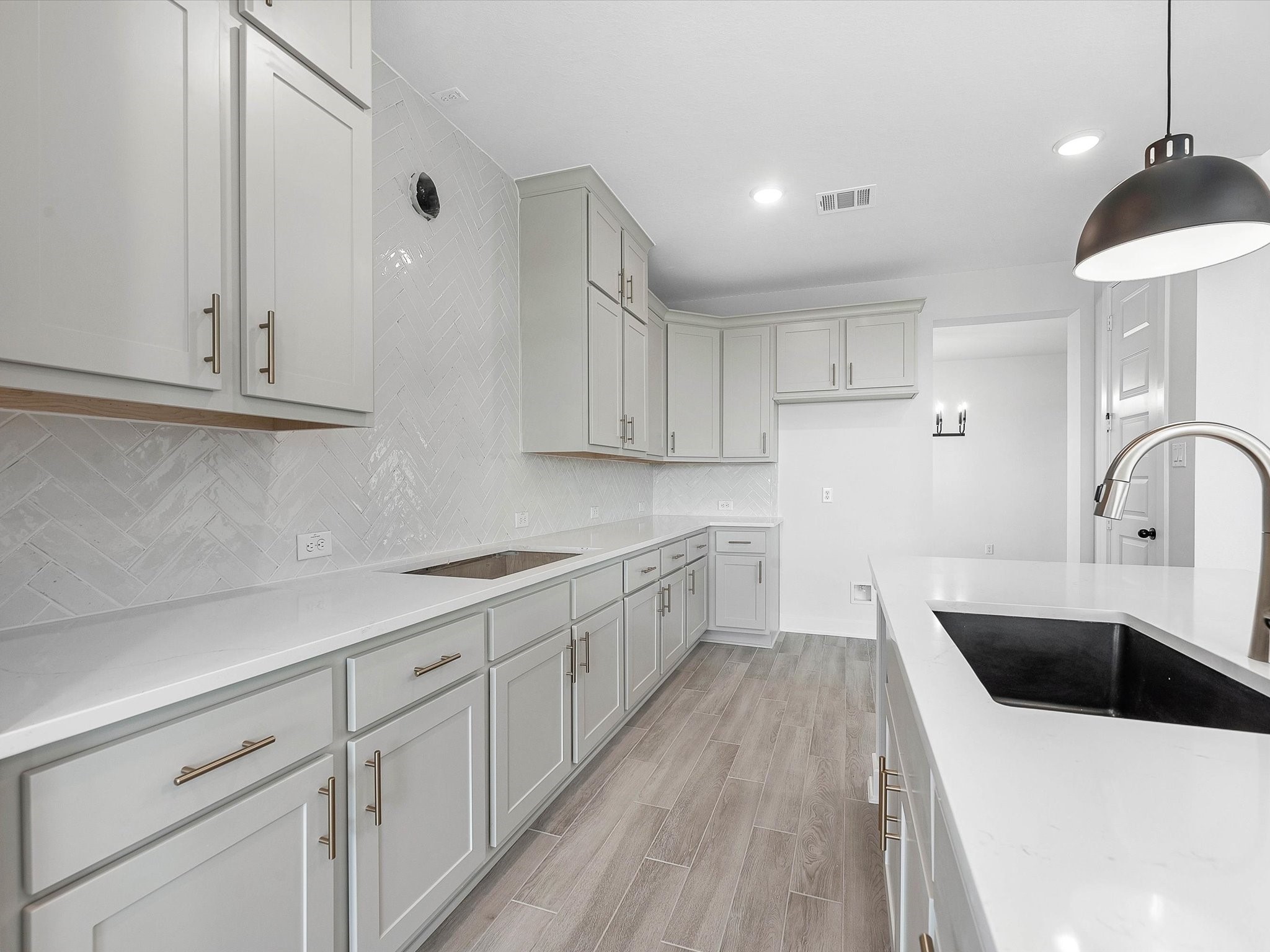 4911 Benton Wds Trail Rosenberg, TX 77471 - Photo 9 of 29 a kitchen with white cabinets a sink dishwasher and a stove with wooden floor