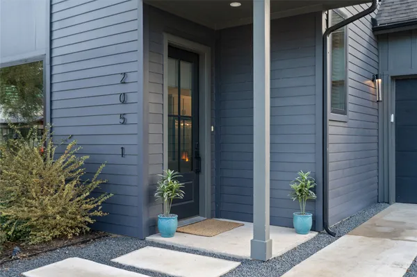 a view of a house with potted plants