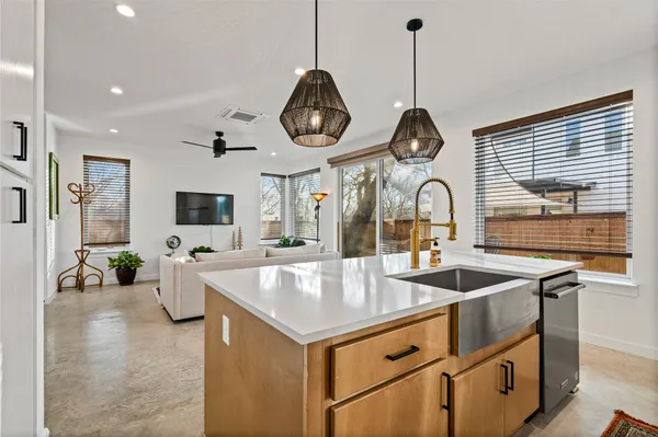 a kitchen with granite countertop a sink stainless steel appliances and cabinets