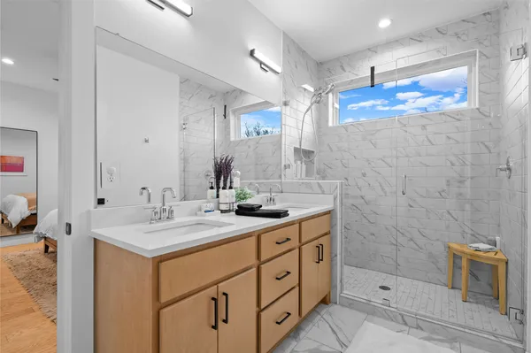 a bathroom with a sink double vanity and a mirror