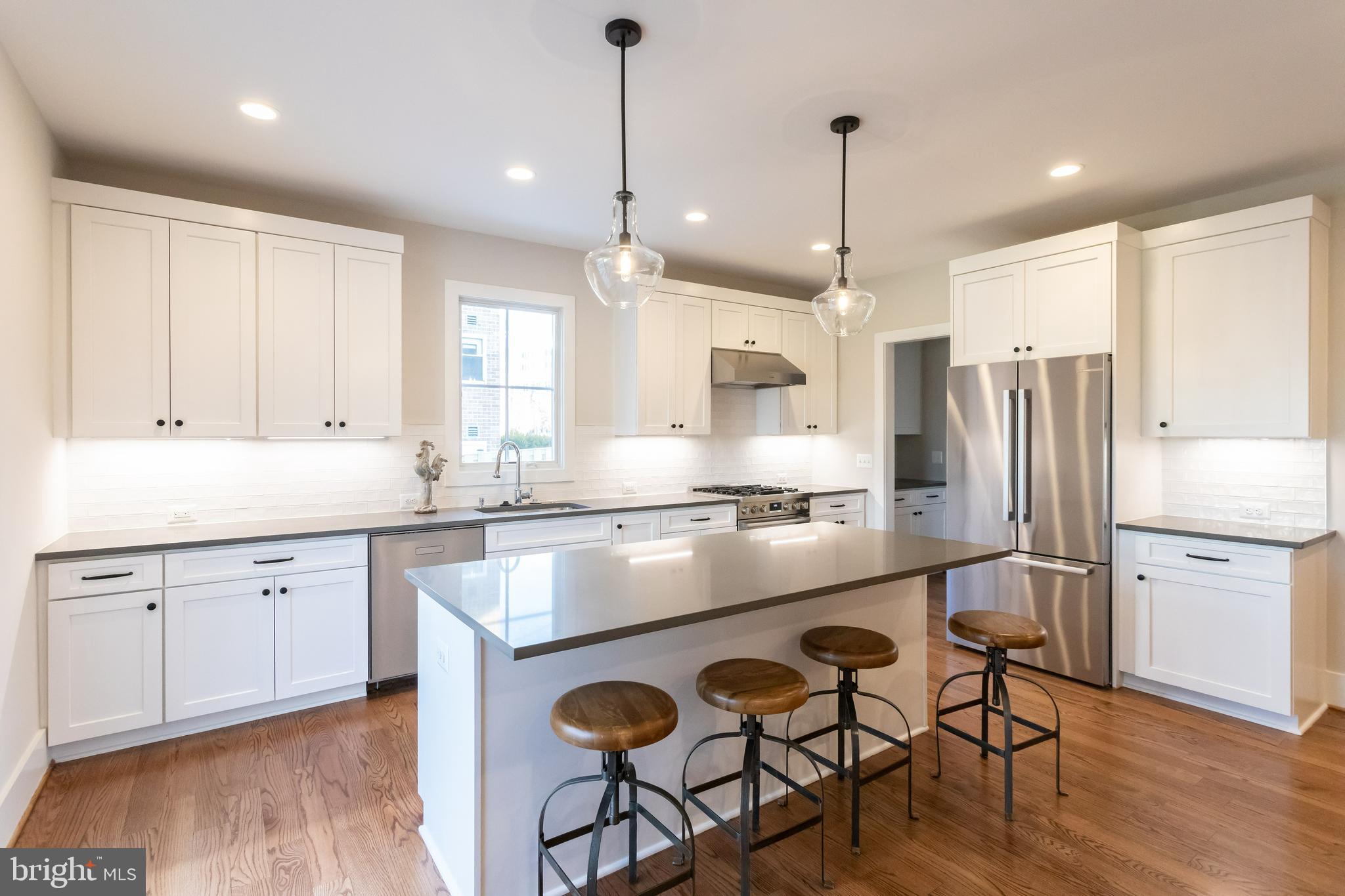 734 North Wakefield Street Arlington, VA 22203 - Photo 12 of 26 a kitchen with kitchen island white cabinets and stainless steel appliances
