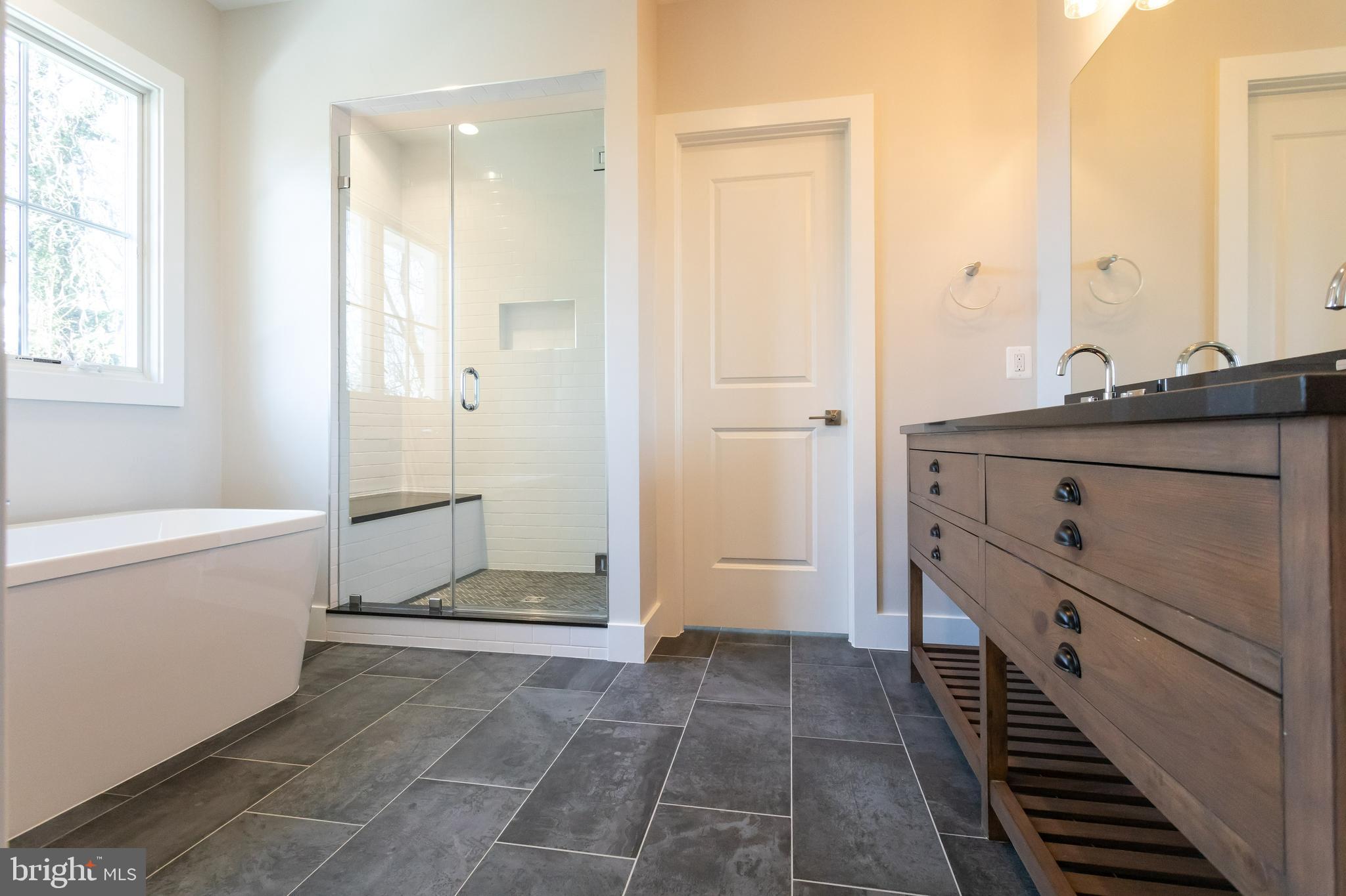 734 North Wakefield Street Arlington, VA 22203 - Photo 15 of 26 a bathroom with a granite countertop sink a toilet and shower