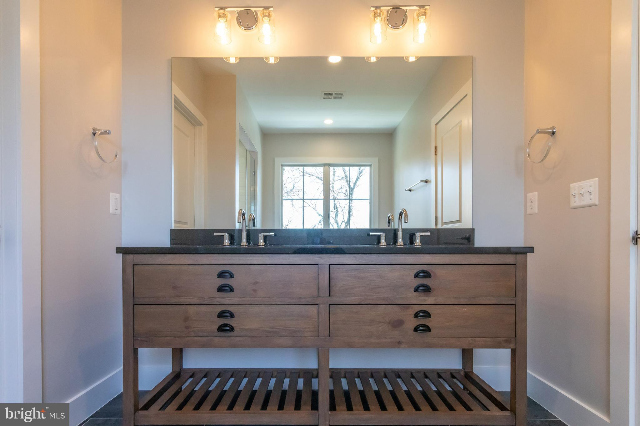 734 North Wakefield Street Arlington, VA 22203 - Photo 17 of 26 a bathroom with a sink a vanity and a mirror