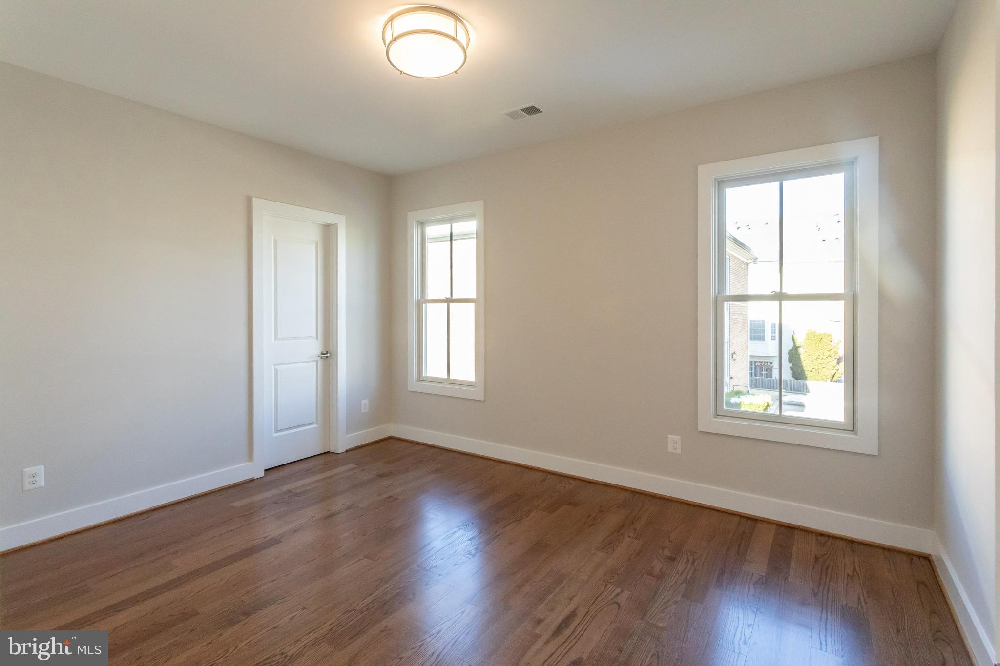 734 North Wakefield Street Arlington, VA 22203 - Photo 20 of 26 an empty room with wooden floor and windows