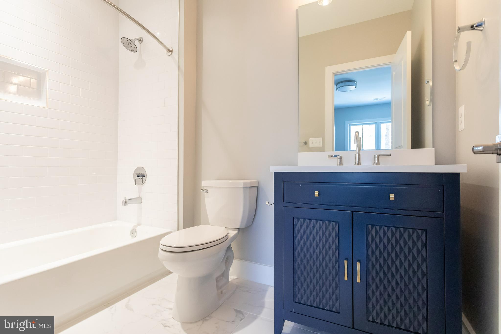 734 North Wakefield Street Arlington, VA 22203 - Photo 23 of 26 a bathroom with a sink a toilet and shower