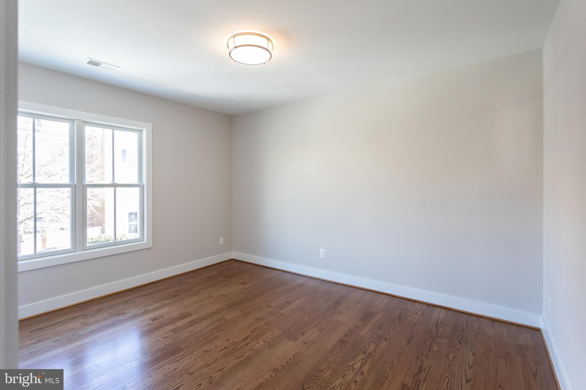 734 North Wakefield Street Arlington, VA 22203 - Photo 24 of 26 an empty room with wooden floor and windows