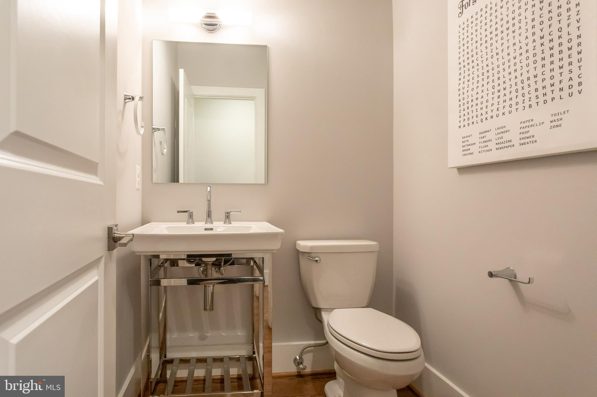 734 North Wakefield Street Arlington, VA 22203 - Photo 6 of 26 a bathroom with a sink a toilet and a mirror