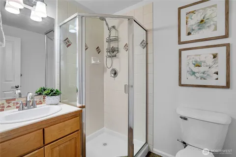 a bathroom with a shower and a sink mirror