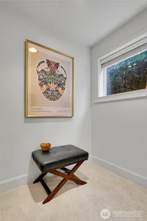 a bench sitting in a room next to a window