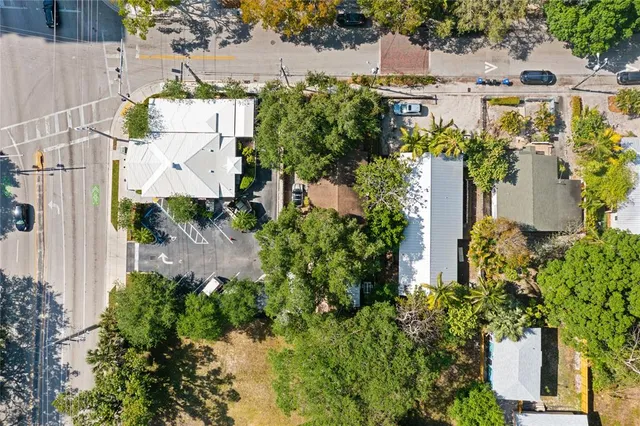 an aerial view of a house with a yard and lake view