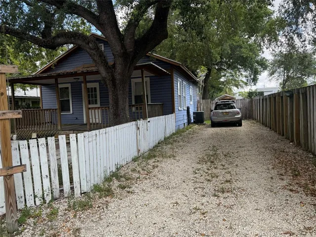 an aerial view of a house with a yard and lake view