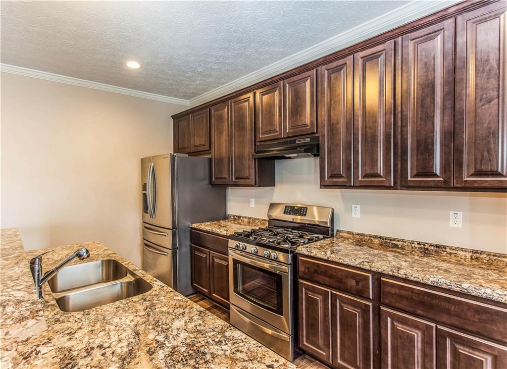 211 West Country Barn Road Houston, PA 15342 - Photo 9 of 25 42" Upgraded Wall Cabinets grace the Kitchen as well as a Double Bowl Sink and Upgraded Counters as well!