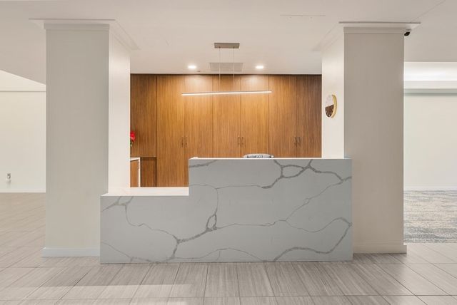 a view of a livingroom with an empty space and a window