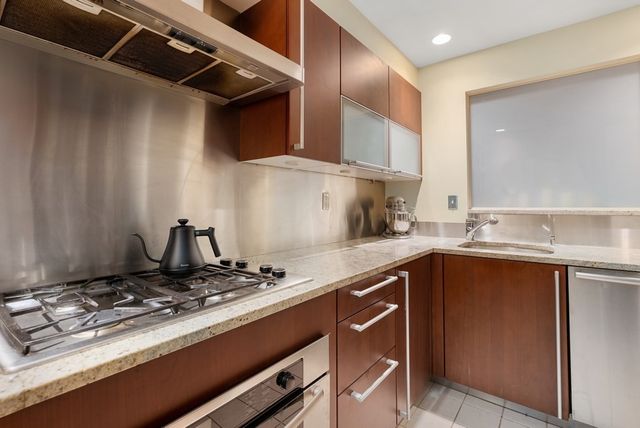 a kitchen with a sink stove and cabinets