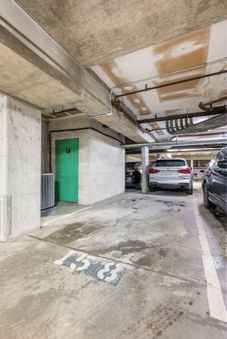 a view of parking garage with cars parked