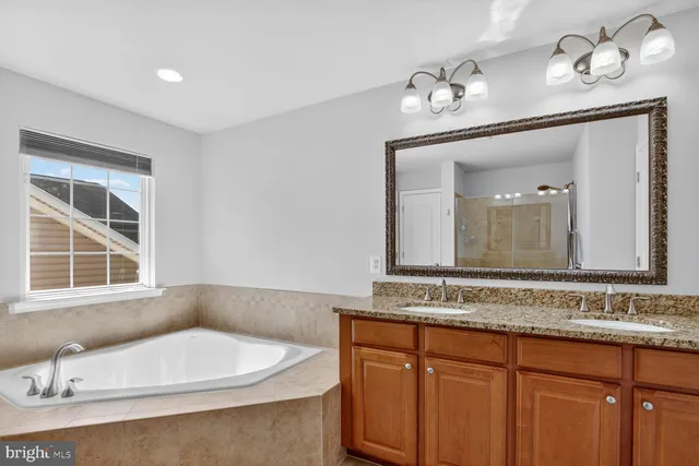 a kitchen with granite countertop kitchen island stainless steel appliances a sink stove and refrigerator