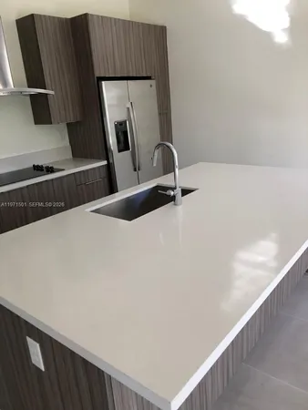 a kitchen with stainless steel appliances a stove microwave and refrigerator