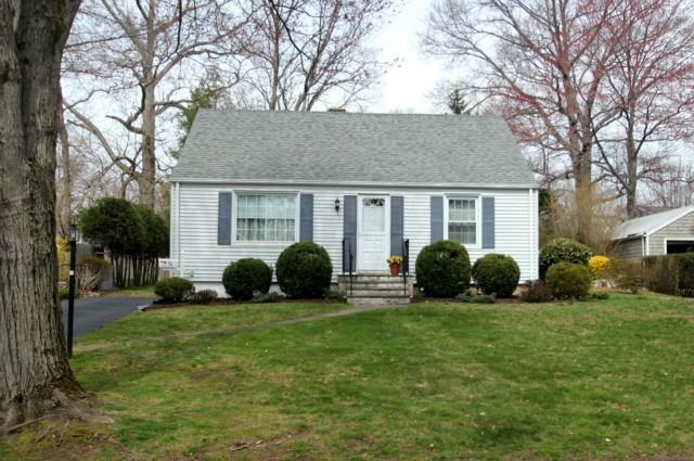 a view of a house with a yard and tree s