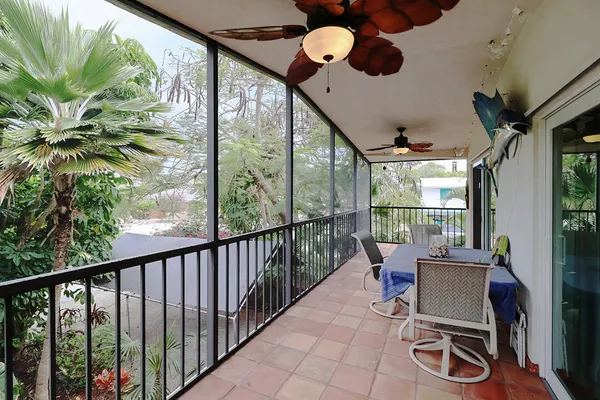 a view of a porch with furniture and a yard