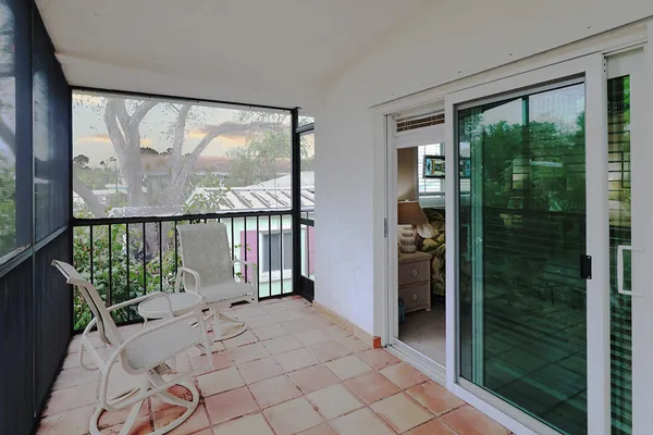 a bedroom with a bed and a tv on the dresser