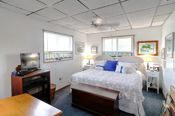 a bedroom with a large bed and a chandelier