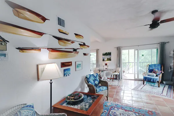 a living room with furniture rug and a window