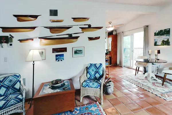 a living room with a book shelf and a book shelf