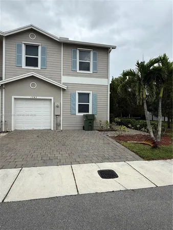 a front view of a house with garage