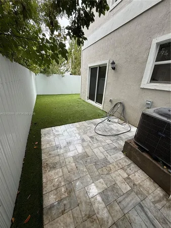 a backyard of a house with yard and outdoor seating