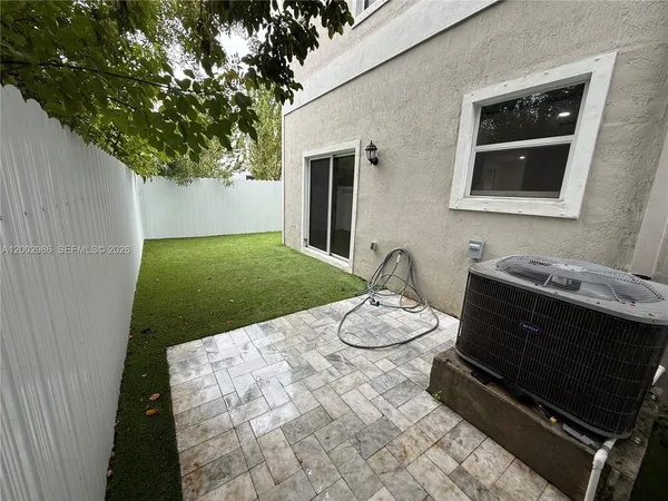 a backyard of a house with table and chairs
