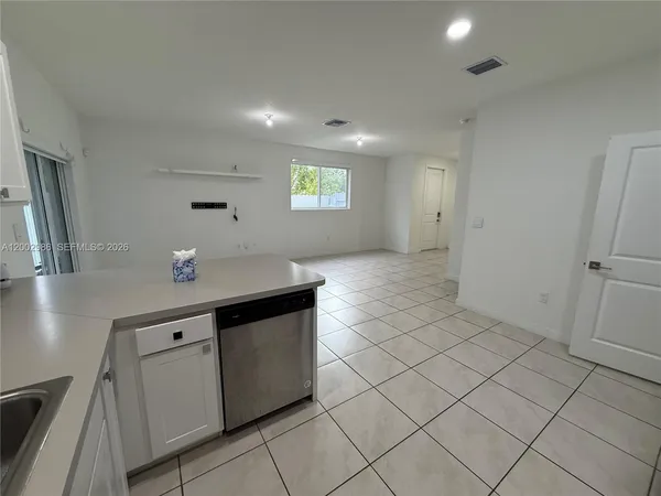 a view of a storage & utility room with cabinets