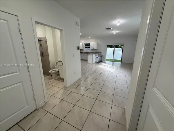 a bathroom with a sink a toilet a mirror and shower