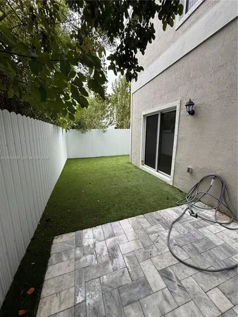 a view of backyard with trampoline