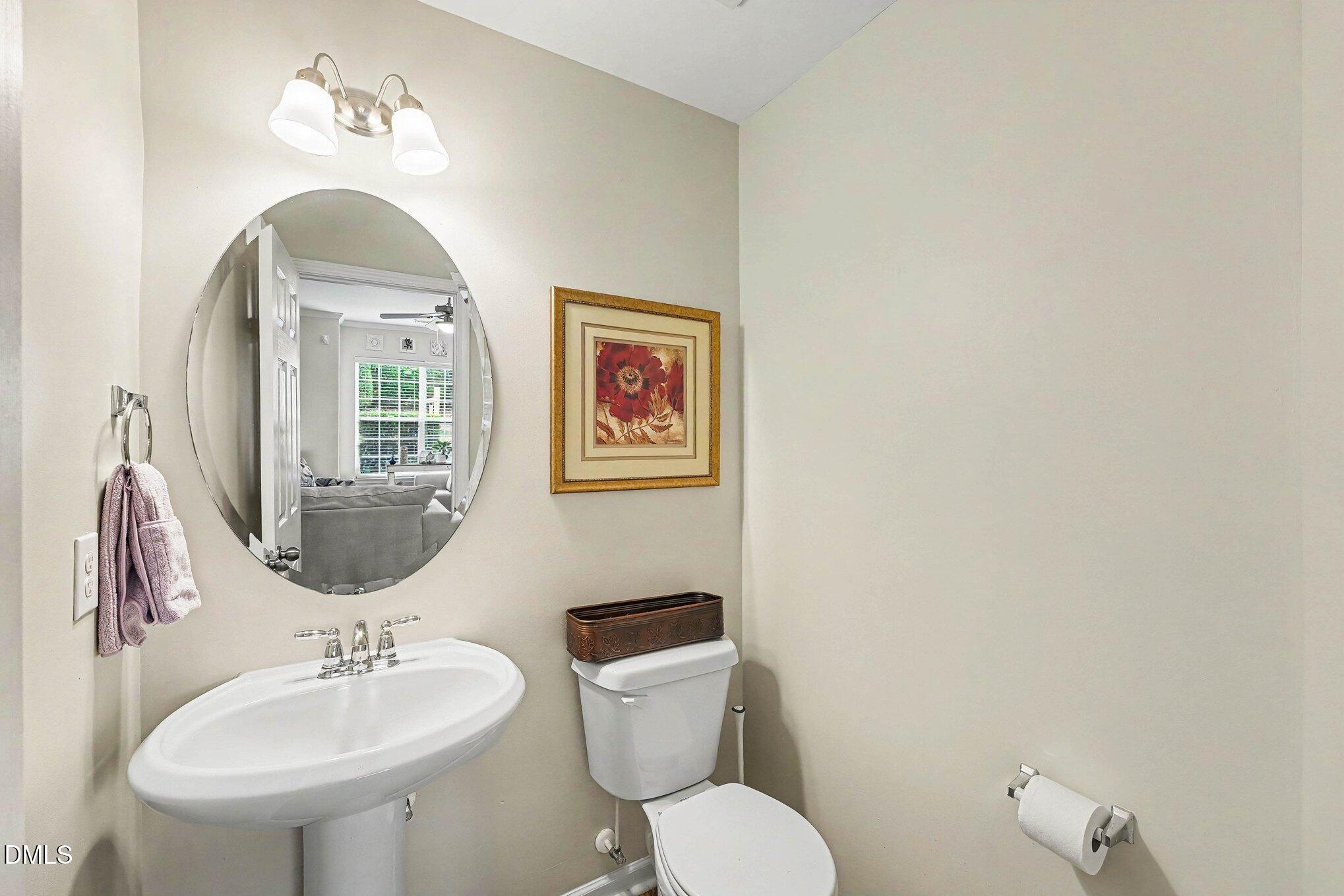 1130 Renewal Place, Unit 106 Raleigh, NC 27603 - Photo 12 of 34 a bathroom with a toilet sink and mirror