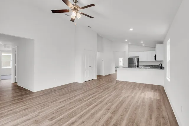 a view of kitchen with wooden floor and electronic appliances