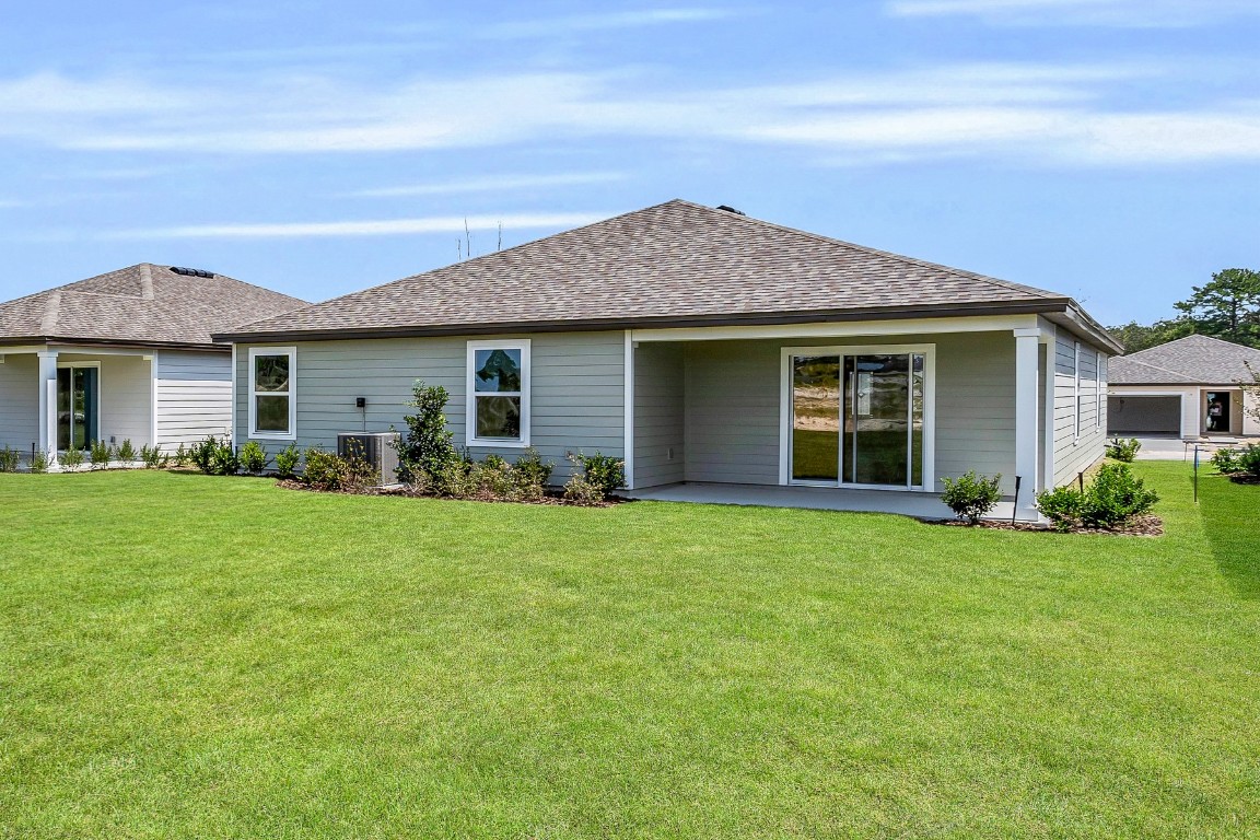 37255 Whisper Way Hilliard, FL 32046 - Photo 3 of 20 a front view of a house with a garden