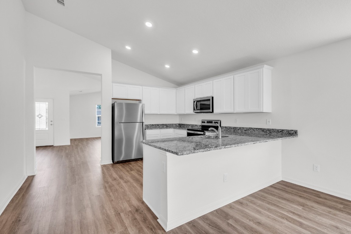 37255 Whisper Way Hilliard, FL 32046 - Photo 8 of 20 a kitchen with stainless steel appliances granite countertop a refrigerator and a stove top oven
