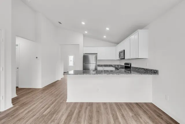 a view of a kitchen with a sink and dishwasher