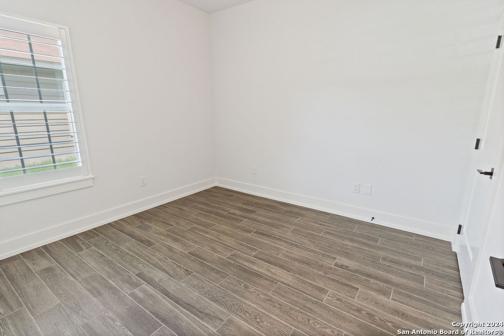 1125 Cedar Grove Trail Spring Branch, TX 78070 - Photo 7 of 23 an empty room with wooden floor and windows